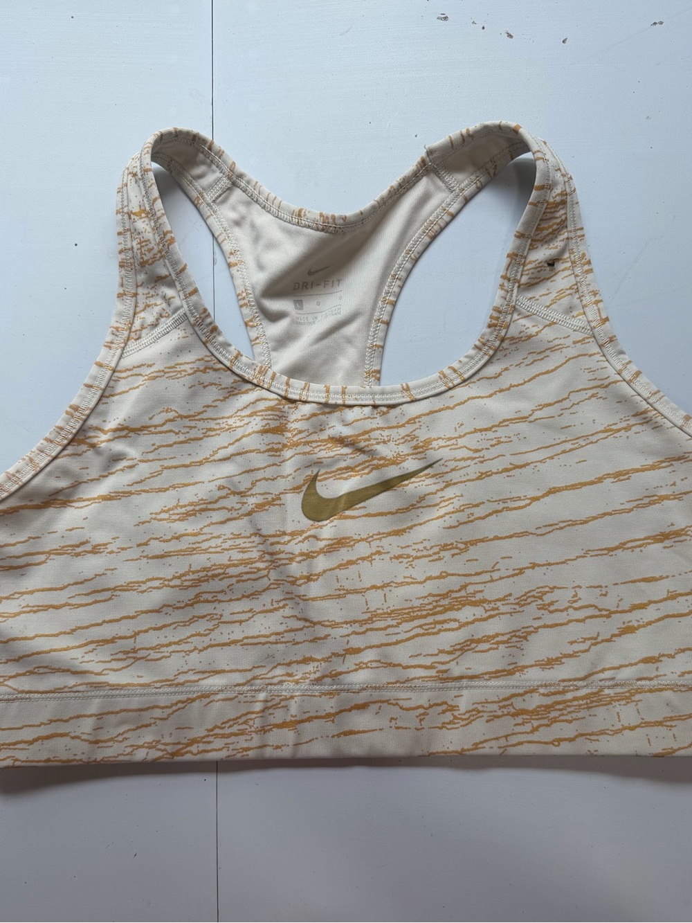 Nike sports bra in a beautiful gold and beige marbled pattern. Size Large